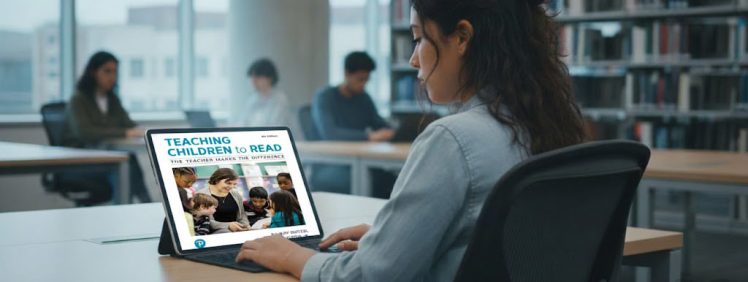 student checking out the book teaching children to read 9th edition in a library on a laptop